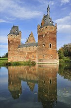 The medieval Beersel Castle reflected in moat