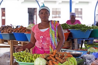 Creole woman selling fresh fruit and vegetables at market in the city Mindelo on the island Sao Vicente