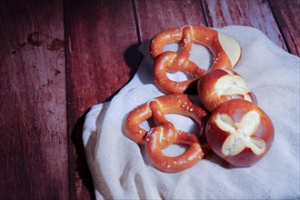 German pretzel called Brezel on a white cloth on a wooden table