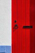 Red wooden door with fittings