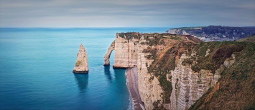 Panoramic view to the famous rock Aiguille of Etretat in Normandy