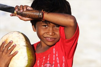 Boy with knife and coconut