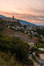 Sunset over the clock tower and fortress of Gjirokaster