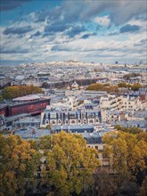 Aerial view over the Paris city to the Sacre Coeur de Montmartre basilica on the hill