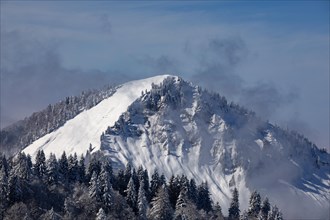 Deeply snow-covered winter landscape with a view of the Faistenau Schafberg