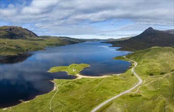 Aerial panorama of the freshwater loch Loch Assynt with the ruins of Ardvreck Castle on a peninsula