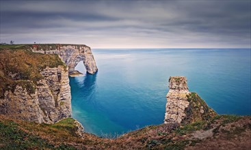 Beautiful view to the Porte d'Aval natural arch at Etretat famous cliffs in Normandy