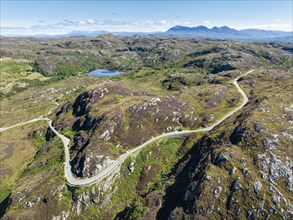 Aerial view of the sparsely populated Northwest Highlands with the single track road and pass road B869