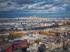Panoramic view over the Paris city to the Sacre Coeur de Montmartre basilica on the hill