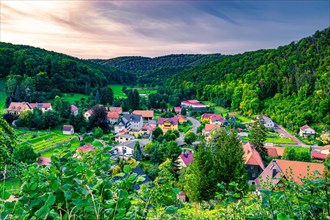 The village of Tautenburg surrounded by mixed forest in summer at sunset