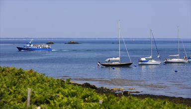 Sailing boats at the roadstead and tourist boat