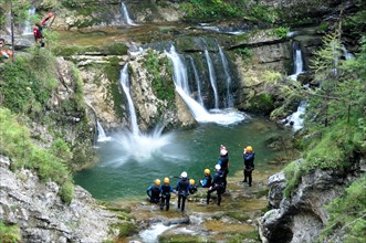 Jumping into the gully while canyoning on the Fischbach stream in the Heutal valley near Unken