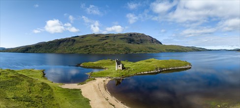 Aerial panorama of the freshwater loch Loch Assynt with the ruins of Ardvreck Castle on a peninsula