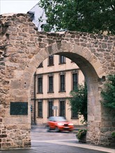 Old city wall behind a car in motion