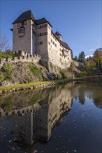 Matzen Castle and the castle pond in autumn