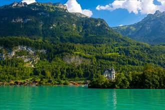 Castle in Iseltwald and Mountain on Lake Brienz in a Sunny Day in Interlaken