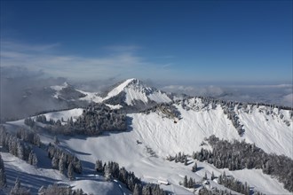 Deeply snow-covered winter landscape with a view of the Faistenau Schafberg