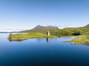 Aerial view of the freshwater loch Loch Assynt with the ruins of Ardvreck Castle on a peninsula