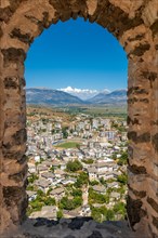 Looking over the city from a window of the Ottoman Castle Fortress of Gjirokaster or Gjirokastra. Albanian