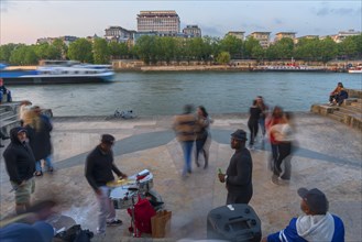Evening dance and music of young people on the banks of the Seine