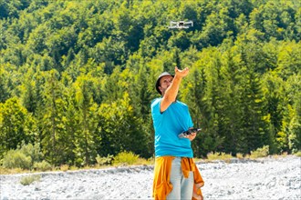 Drone pilot man flying the drone on the mountain in Valbona natural park. Albania