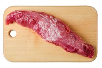 Top view of whole raw tenderloin pork fillet on wooden cutting board