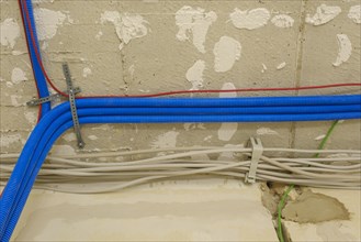 Electric cables and conduits under the ceiling