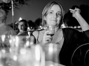 Woman at dinner party outdoor in summer
