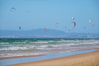 Kiteboarding kitesurfing kiteboarder kitesurfer kites on the Atlantic ocean beach at Fonte da Telha beach