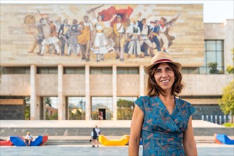 Portrait of a tourist woman at the entrance to the National Historical Museum in Skanderbeg Square in Tirana. Albania