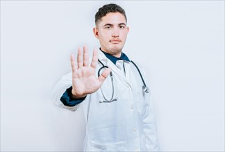 Young doctor counting number 5 on isolated background. Doctor counting number five isolated