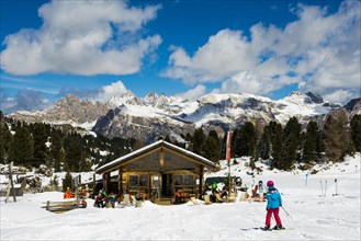 Snow-covered mountains and ski hut
