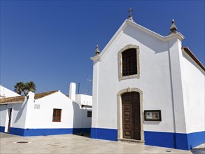 Church painted blue and white in village square