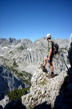 Climber on via ferrata enjoying the view of the Wilder Kaiser on the ascent to Laerchegg