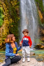 Portrait of mother with her son Grunas waterfall of Theth national park in summer