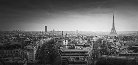 Black and white Paris panorama. Romantic aerial view over rooftops to the Eiffel Tower