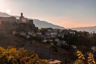 Sunset view over the clock tower and fortress of Gjirokaster