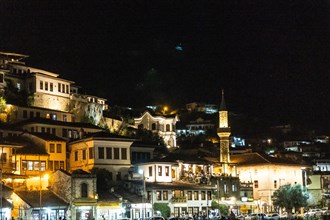 Detail of houses and a mosque in the illuminated historic city of Berat in Albania