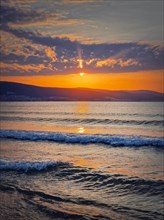 Vibrant sunrise at the Bulgarian coastline of Black Sea. Sunny beach resort