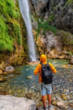 Hiker at Grunas waterfall in Theth national park
