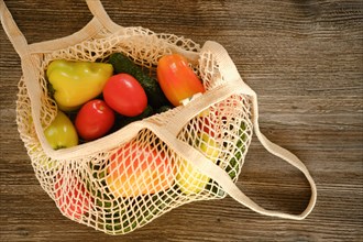 Top view of fresh vegetables in reusable string bag