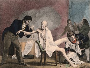 An emaciated old man being treated by four doctors