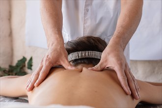 Woman lying and having back massage at spa. Healthy lifestyle and relaxation concept