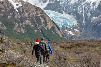 Hikers walking towards a glacier on the way to Laguna de los tres