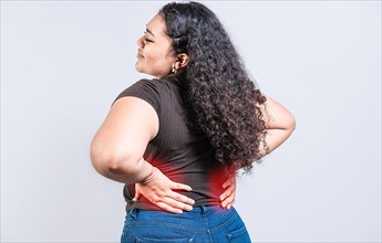 Woman with back pain on isolated background. lumbar problems concept. People with spine problems
