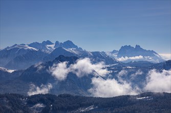 Winter landscape covered in deep snow with a view of the Osterhorn group and the Dachstein massif