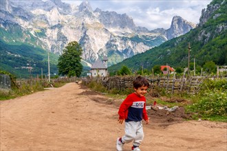 A very happy child running in the valley of Theth national park