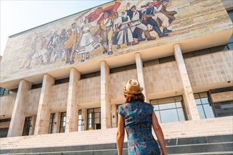A female tourist at the entrance visiting the National Historical Museum in Skanderbeg Square in Tirana. Albania