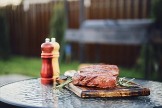 Selective focus photo of grilled strip loin steaks on backyard