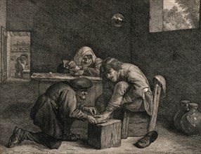 A surgeon treats the foot of a male patient